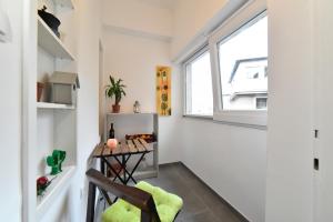 a small room with a table and a window at Cosy Lu Apartment in Zagreb
