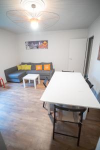 a living room with a white table and a couch at Stuart in Dinard