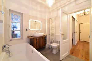 a bathroom with a tub and a sink and a toilet at Cosy Lu Apartment in Zagreb