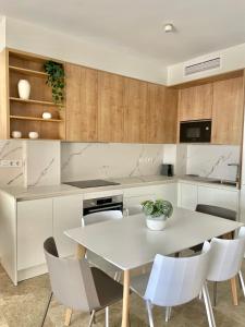 a kitchen with a white table and chairs at The Retreat House - Private Pool in Puerto de Santiago +15 photos