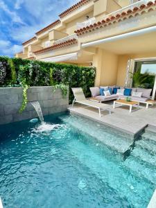 a swimming pool in the backyard of a house at The Retreat House - Private Pool in Puerto de Santiago