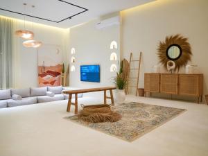 a living room with a couch and a table at Pool Villa Jebel Jais in Şāliḩīyah