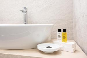 a white bathroom with a sink and a toilet at la dimora di Cornelia in Sorrento