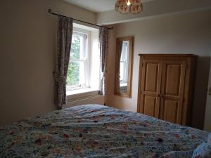 a bedroom with a bed and a window at Gorgeous private apartment mesmerising sea views in Teignmouth