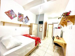 a bedroom with a bed and a table in it at Vila Vasconcelos in Itacaré