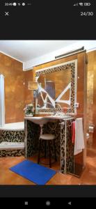 a bathroom with a table and a mirror at Kosmira Big House in Ioannina