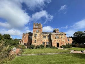 an old castle on a grassy field at Dalston Hall in Carlisle