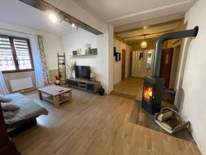 a living room with a wood burning stove in it at Gîte À l'aigle de sable in Kintzheim