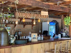 a restaurant with a bar with plates and a counter at Ta Xua Ecolodge in Bắc Yên