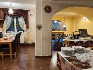 a dining room with a table with plates on it at Villa Edel Constanta in Constanţa