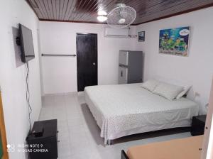 1 dormitorio con cama y puerta negra en Posada Miss Mazie, en San Andrés