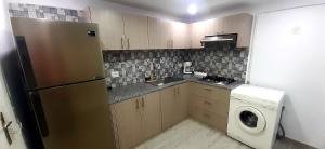 a kitchen with a refrigerator and a washing machine at Dar salah in Hammamet