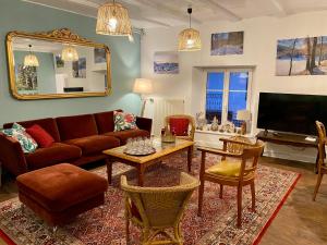 a living room with a couch and a table at Hostellerie Alsacienne de Masevaux in Masevaux