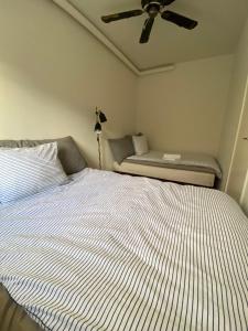 1 dormitorio con 1 cama y ventilador de techo en Central Ground Floor Apartment with Parking en Aarhus
