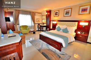 a hotel room with a bed and a living room at S79 Sunflower Hotel & Spa in Ho Chi Minh City