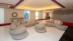 فندق ازدان الدوحة في الدوحة: غرفة معيشة بها كنب وكرسيين