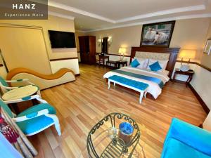 a hotel room with a bed and a living room at S79 Sunflower Hotel & Spa in Ho Chi Minh City