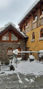 a house with snow on the front of it at Agriturismo Belotti in Tem&ugrave;