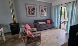 a living room with a couch and a table at Clarens, Paddocks 23 in Clarens