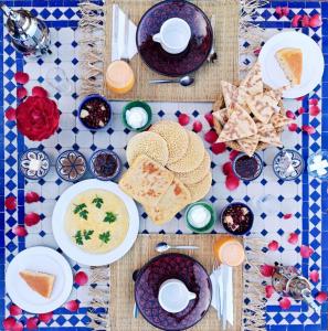 a table with plates of food on a table at Kasbah Chems in El Kelaa des Mgouna