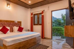a bedroom with a bed and a large window at Vanasathli I Near Mall Road Kasauli I Open Garden & Rooftop in Kasauli