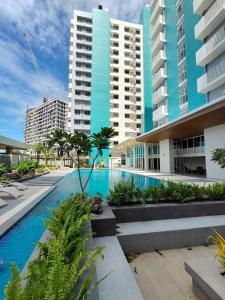 a swimming pool in front of some tall buildings at The URBANSTAY Bacolod City in Bacolod