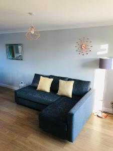 a blue couch sitting in a living room at Dunfermline Home with Free Parking Near Amazon & M90 in Dunfermline
