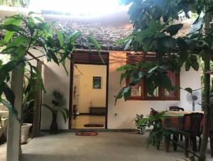 a room with a table and a house at Yunal's Place in Matara