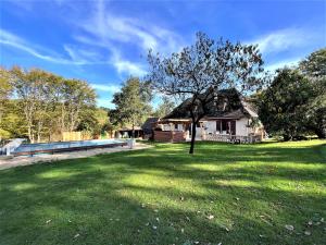 a house with a large yard with a tree at Chez Pascaline in Sarliac-sur-lʼIsle