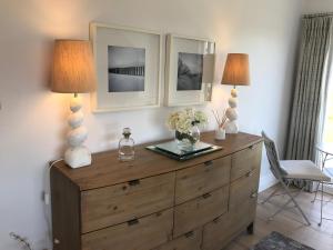 two lamps on top of a dresser in a room at Woodlands Coastal Apartment in Southerndown