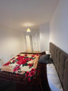 a bedroom with a bed with a quilt on it at Amazing apartment moments away from the heart of London in London