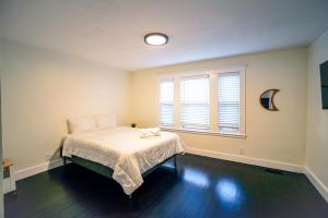 a bedroom with a bed and a window at Modern Two Bedroom Condo - Boston in Stoneham