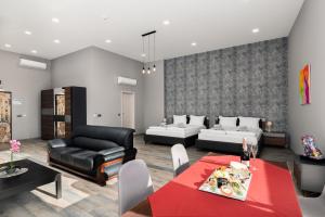 a living room with a couch and a table at Art Magus Hotel in Sofia