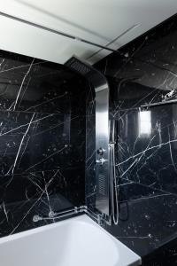 a bathroom with a black marble counter top at Deluxe Διαμερισμα in Patra