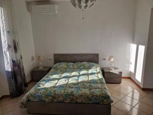 a bedroom with a bed and two night stands at La Casa sull'argine in Sarzana