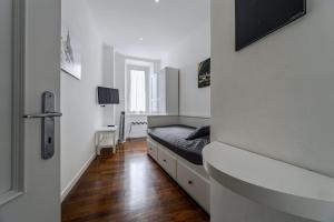 a bedroom with a bed in a white room at Saint Peter House Station in Rome