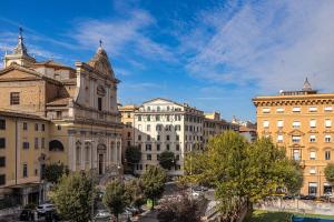 a group of buildings in a city with a blue sky at Saint Peter House Station in Rome