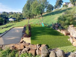 a park with a playground on a hill at Le Bouchatou (meublé touristique neuf)*** in Saint-Front