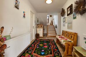 a living room with a rug on the floor at Gradina Lu' Ion - Adults Only in Vişeu de Sus