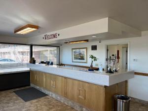 a kitchen with a large counter and a large window at Oquirrh Mountain Inn in Tooele