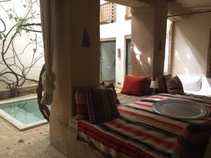a bedroom with a bed and a large window at Dar Zahia in Taroudant