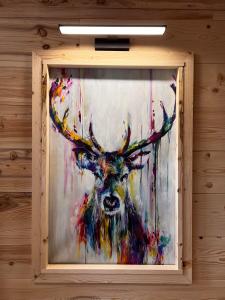 a painting of a reindeer on a wall at Les appartements Makalu Val Thorens in Val Thorens