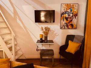 a living room with a chair and a staircase at VILLA SANTONI in Porticcio