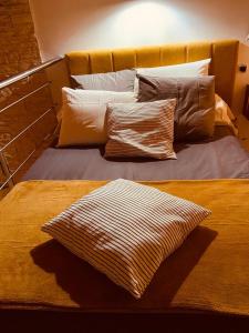 una cama con varias almohadas encima en VILLA SANTONI en Porticcio