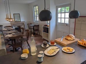 a kitchen with a table with plates of food on it at Le 14 Faubourg in Beaune