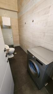 a washing machine in a bathroom with a toilet at David Hameleh House in Netanya +133 photos