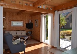 ein Wohnzimmer mit einem Sofa und einer Glasschiebetür in der Unterkunft Ferienhaus Kreischberg in Sankt Lorenzen ob Murau
