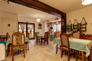 a dining room with green tables and chairs at Gradina Lu' Ion - Adults Only in Vişeu de Sus