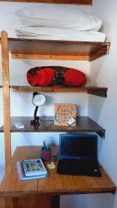 a desk with a laptop computer on a desk under a bunk bed at Casas Vasconcelos in Itacaré
