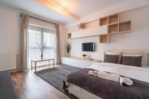 - une chambre avec un grand lit et une télévision dans l'établissement 21 Residence Studio, à Bucarest